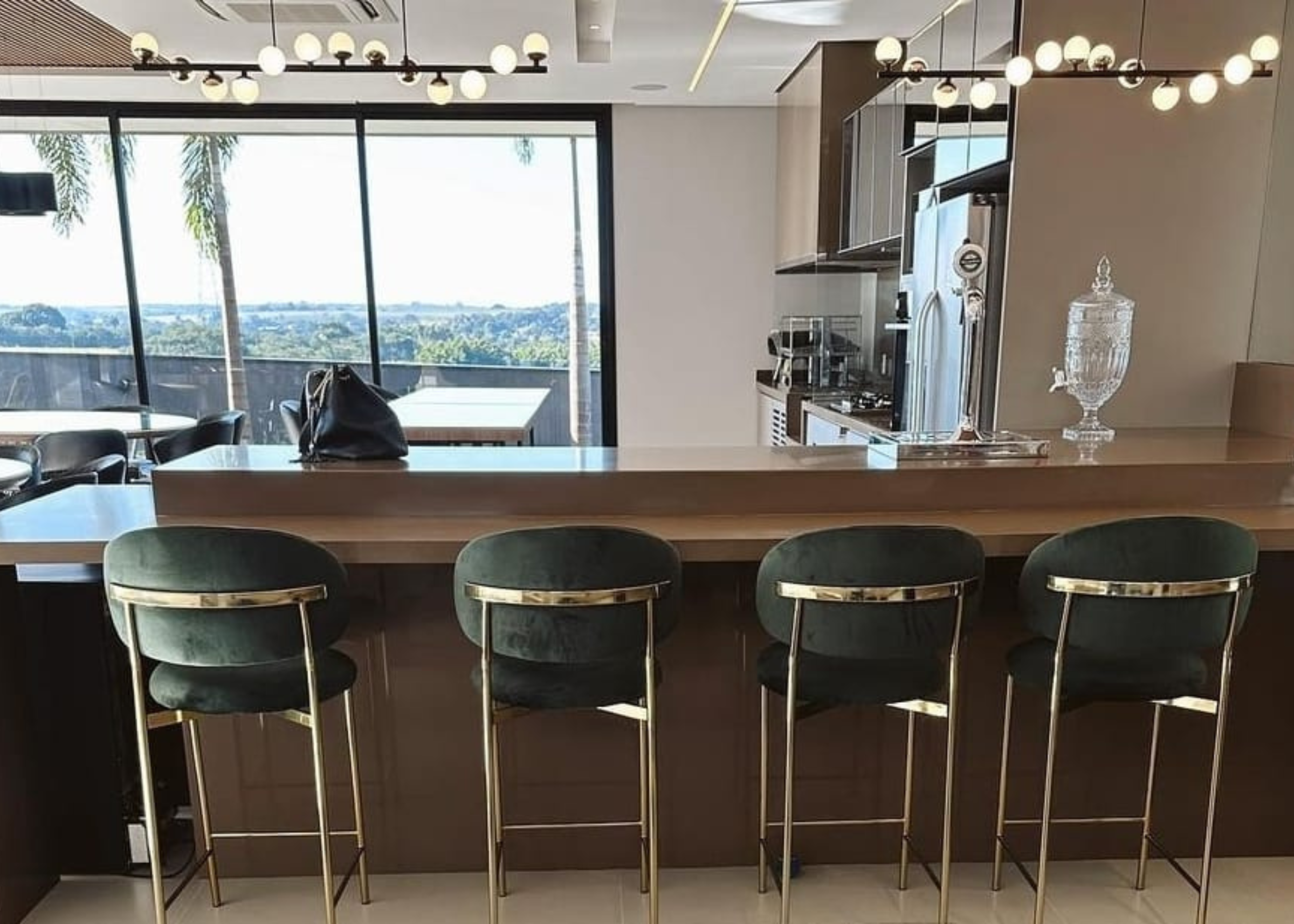 Banqueta Master estofada em tecido verde, ambientada em cenário moderno e luxuoso. Móvel sofisticado e confortável para bancadas e áreas gourmet elegantes.