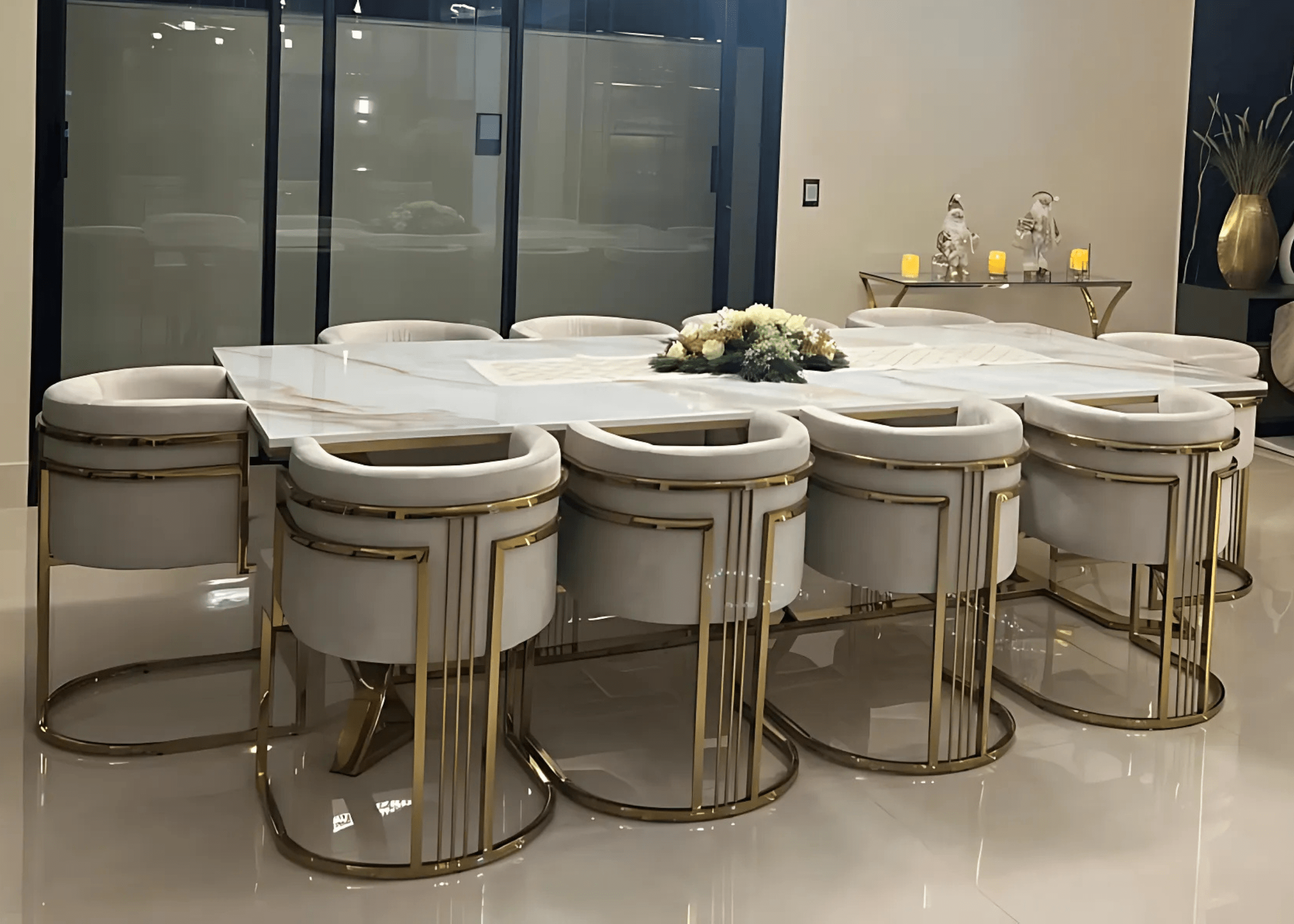 Conjunto de jantar Gregori com mesa marmorizada e poltronas douradas.