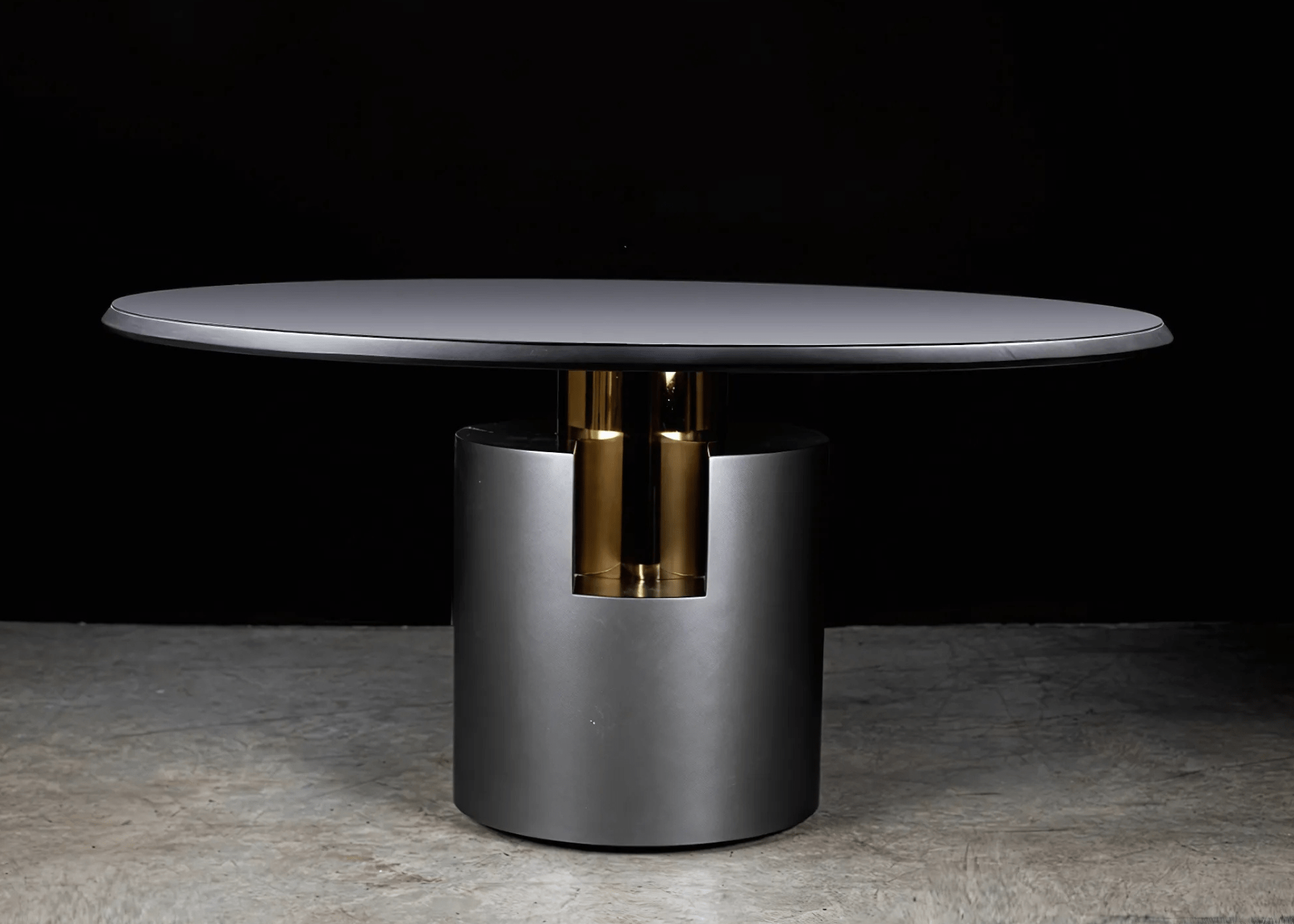 Mesa redonda de jantar Theodoro com tampo moderno e base cilíndrica cinza com inox dourado em destaque.