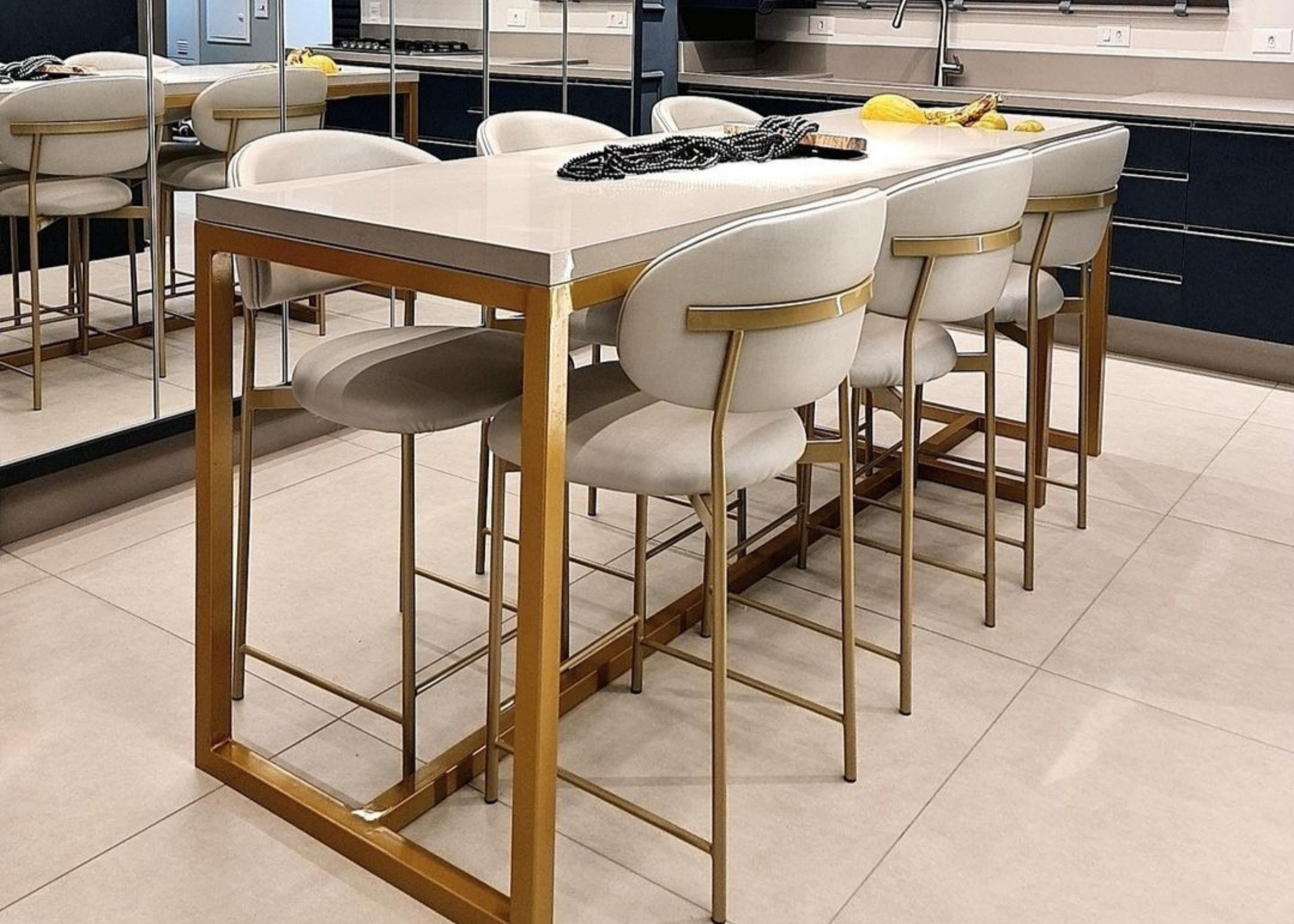 Banqueta Master moderna estofada em tecido off-white, ambientada em cenário sofisticado. Móvel elegante e funcional para bancadas e áreas gourmet contemporâneas.