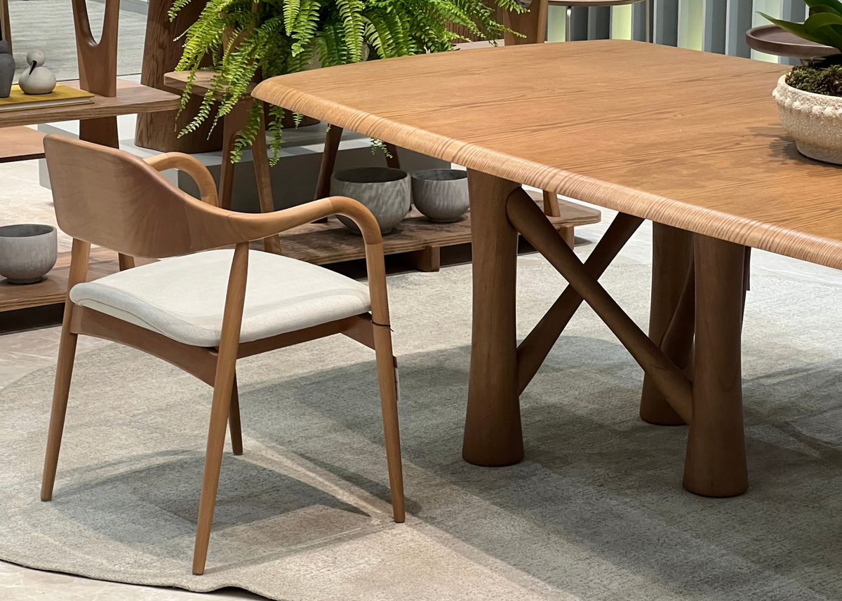 Cadeira Laura com estrutura de madeira maciça, assento estofado e encosto curvo, proporcionando conforto e elegância