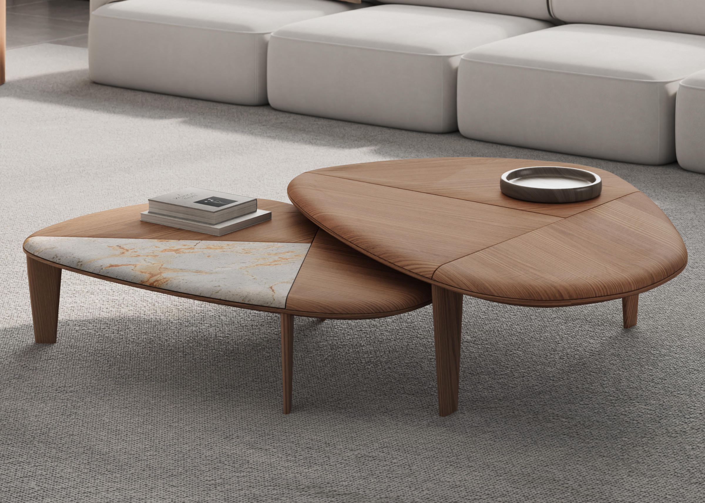 Mesa de centro com formato orgânico e detalhe no tampo em mármore Calacata. Design fluido e elegante, ideal para composições contemporâneas.

