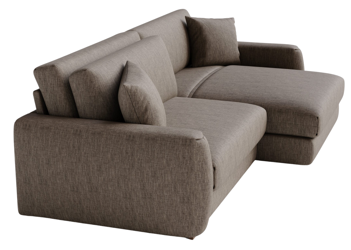 Sofá Aurum em vista lateral com almofadas decoradas, apresentando design elegante e sofisticado, ideal para compor ambientes modernos e refinados.